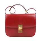 CELINE Classic Box Medium shoulder bag in smooth red calfskin leather with structured flap design, adjustable strap, and gold-tone push-lock closure.