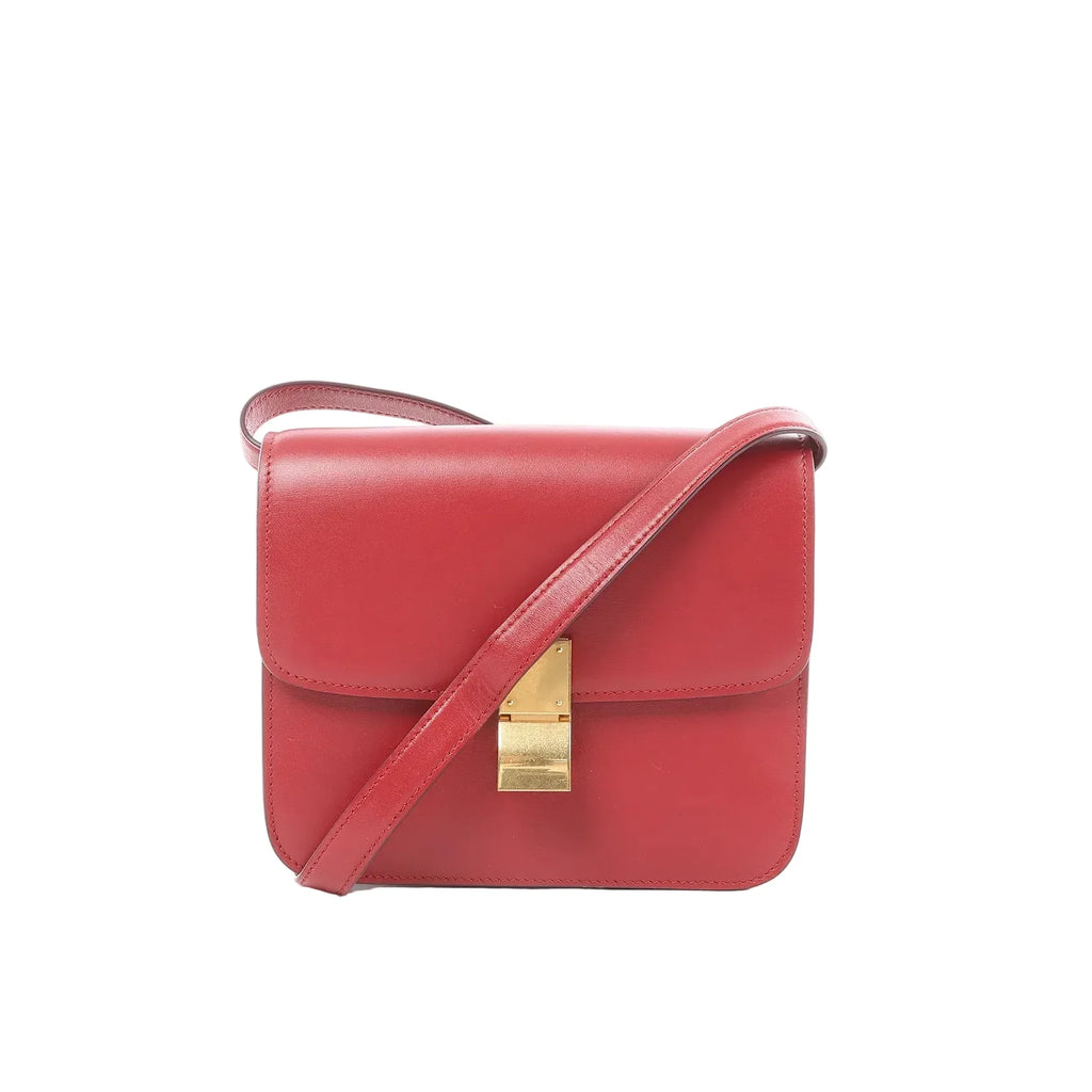 Celine Classic Box Small red leather crossbody bag with flap front, gold-tone clasp closure, and matching red shoulder strap