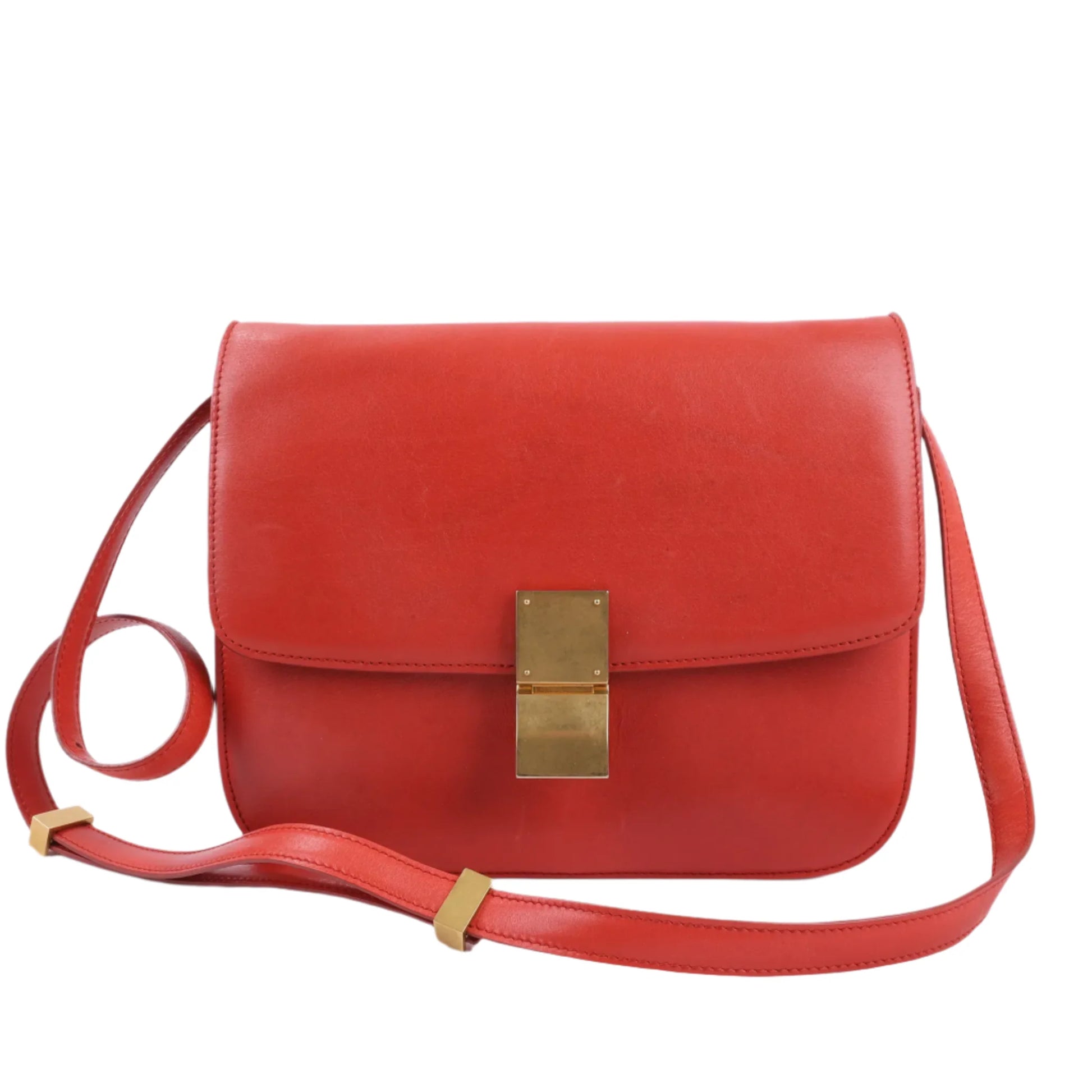 Front view of CELINE Classic Box Medium Leather Shoulder Bag in red smooth leather with adjustable strap and gold-tone rectangular push-lock clasp, displayed against a plain white background.