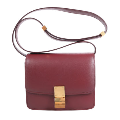 Red handbag with a gold clasp on a white background