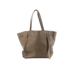 Celine Cabas Phantom Small taupe grained leather tote with long shoulder straps and side tie details on a white background