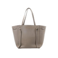 Celine Cabas Phantom Small tote in taupe grained leather with two long shoulder straps and a structured open-top silhouette.