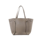 Celine Cabas Phantom Small tote in taupe grained leather with two long shoulder straps and a structured open-top silhouette.