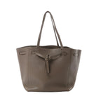 Céline Cabas Phantom Small taupe grained leather tote with shoulder straps and front tie detail, front view on white background.