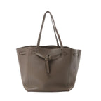 Céline Cabas Phantom Small taupe grained leather tote with shoulder straps and front tie detail, front view on white background.