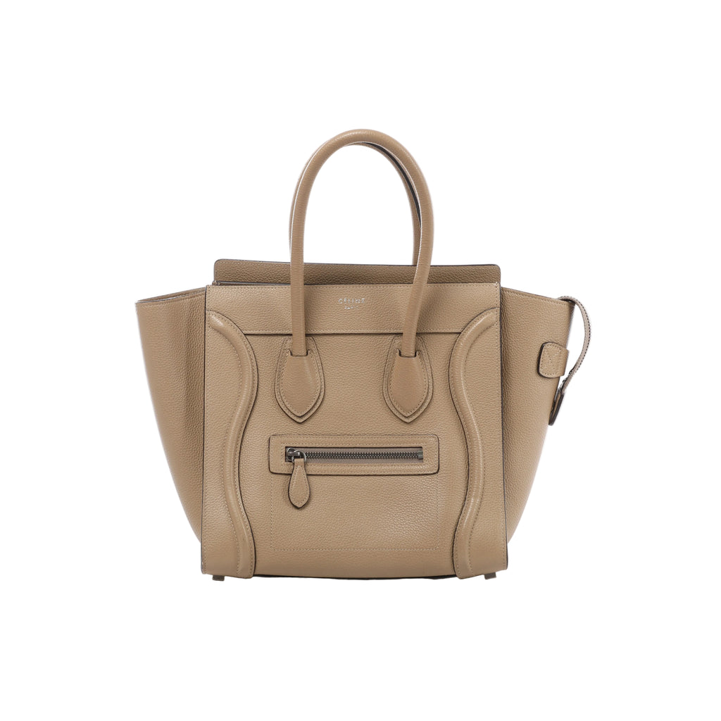 Front view of Celine Luggage Micro beige grained leather handbag with flared sides, rounded top handles, curved leather trim and a front zip pocket.