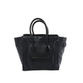 Celine Luggage Micro handbag in black grained leather with rolled top handles, winged sides and a front zip pocket.