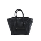Celine Luggage Micro handbag in black grained leather with rolled top handles, winged sides and a front zip pocket.