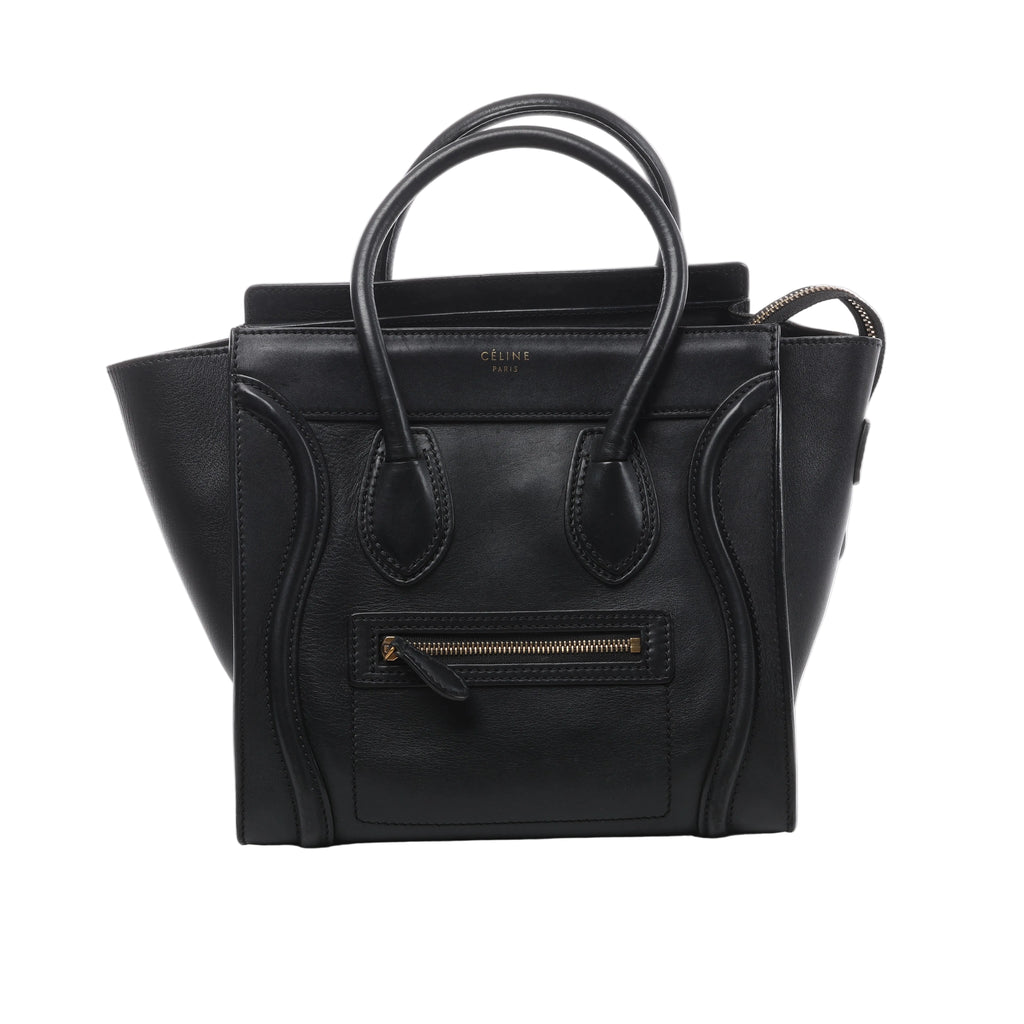 Black Celine Luggage Micro Shopper leather handbag with double top handles, winged sides, curved front piping, front zip pocket and gold-tone logo.