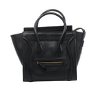 Black Celine Luggage Micro Shopper leather handbag with double top handles, winged sides, curved front piping, front zip pocket and gold-tone logo.