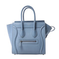 Celine Luggage Micro handbag in light blue grained leather with rolled top handles, winged sides and a front zip pocket.