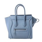Celine Luggage Micro handbag in light blue grained leather with rolled top handles, winged sides and a front zip pocket.