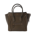 Celine Luggage Micro handbag in khaki smooth leather with rolled top handles, signature front zip pocket, winged side panels and gold-tone hardware, displayed against a white background.