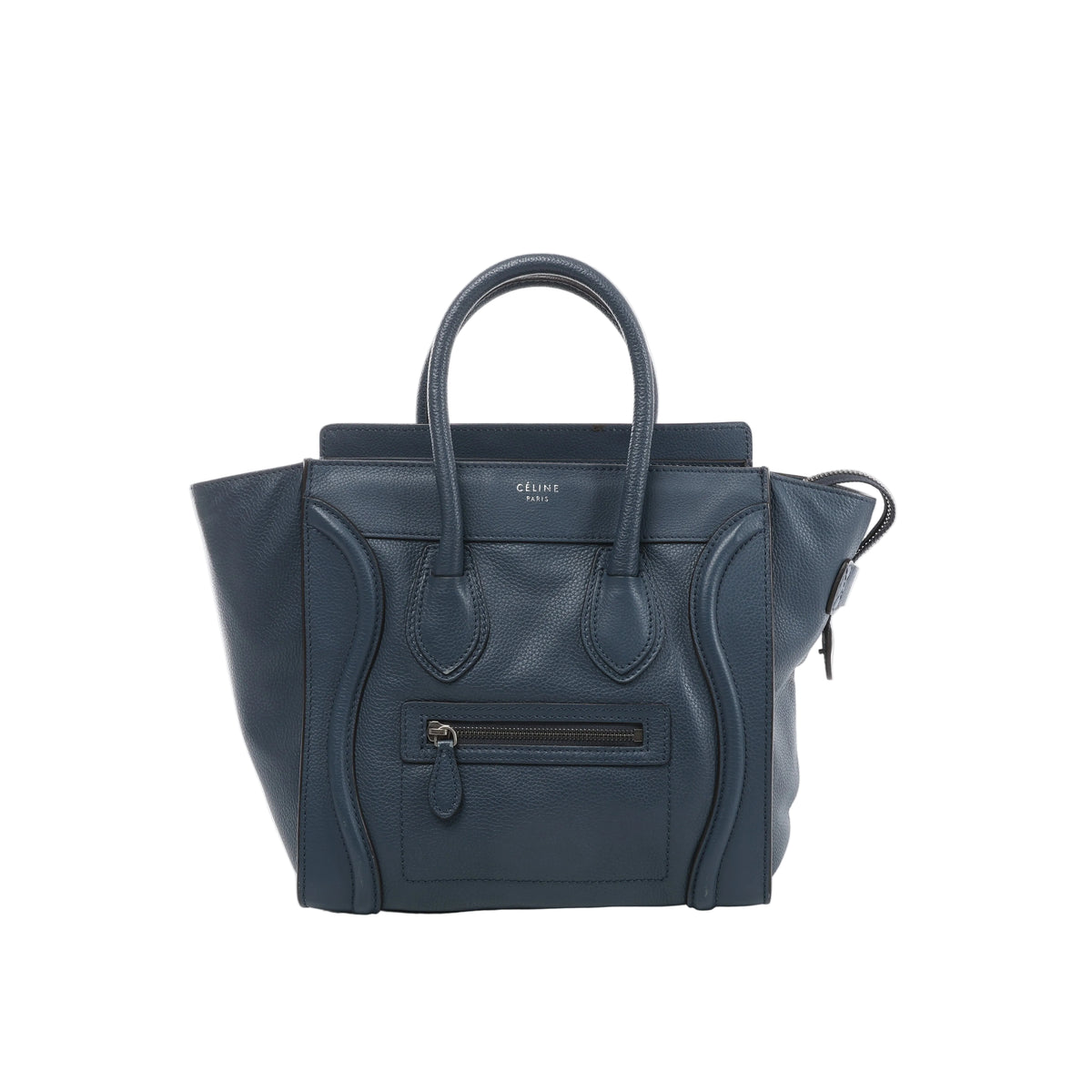 Front view of Celine Luggage Micro navy blue grained leather handbag with flared sides, rounded handles, curved leather trim and a front zip pocket.