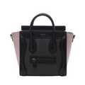 Black Celine Luggage Nano handbag with pale pink side panels, rounded top handles, silver-tone hardware and signature front zip pocket.