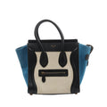 Celine Luggage Micro handbag with black leather trim and top handles, beige canvas front panel, blue side panels, and a front zip pocket with leather pull, shown on a white background.
