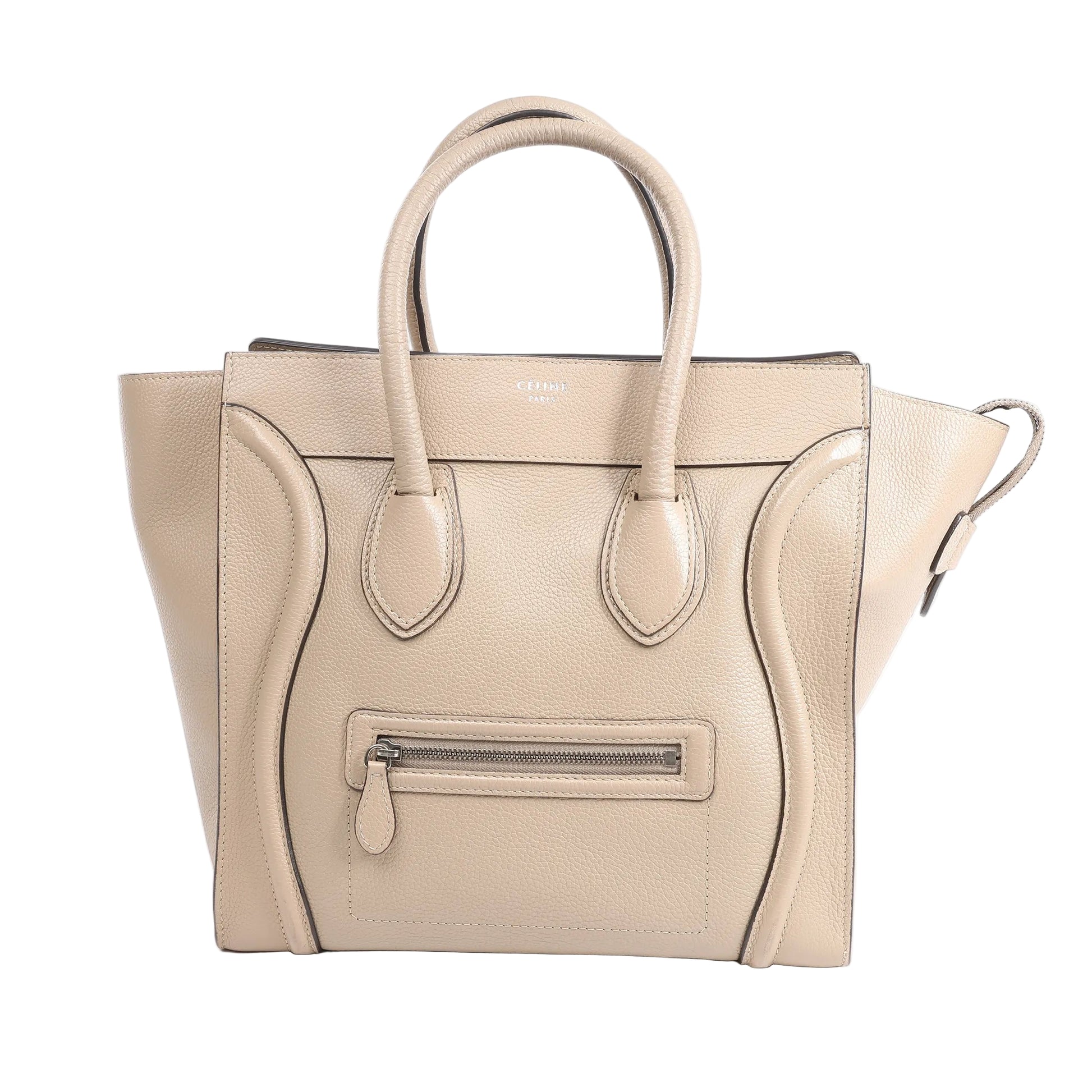 Celine Luggage Mini Leather Handbag in beige grained leather with dual rolled handles, winged sides, front zip pocket, and structured silhouette, shown standing upright against a white background.