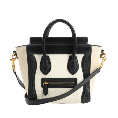 CELINE Nano Luggage 2Way handbag in black and white grained leather with top handles, front zip pocket, and detachable shoulder strap.