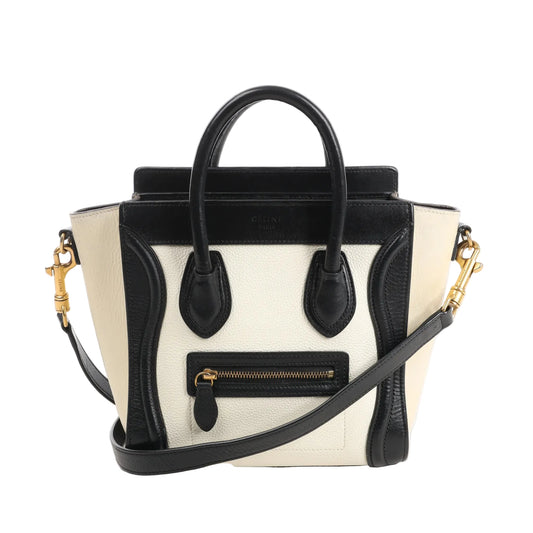 CELINE Nano Luggage 2Way handbag in black and white grained leather with top handles, front zip pocket, and detachable shoulder strap.