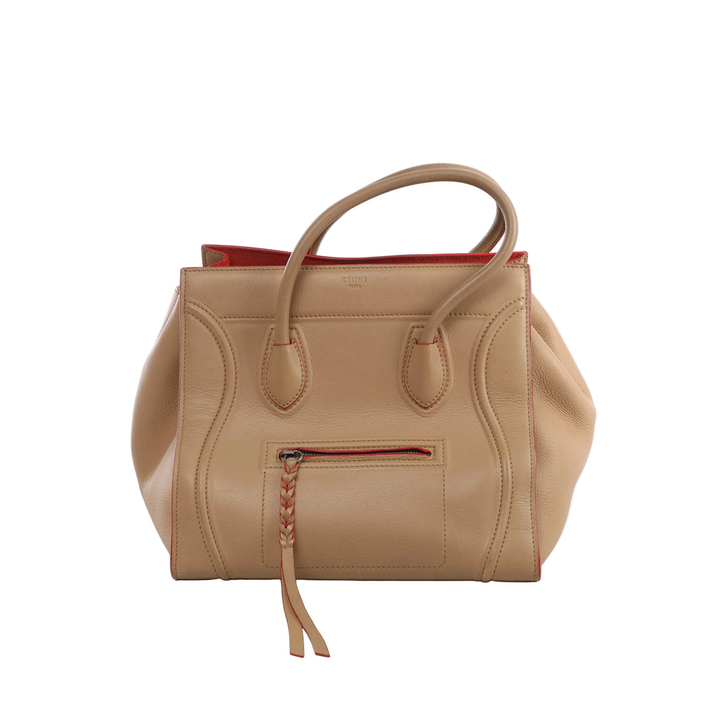 Beige Celine Luggage Phantom leather handbag with rounded top handles, red edge accents, sculpted piping and front zip pocket with braided pull.