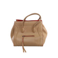 Beige Celine Luggage Phantom leather handbag with rounded top handles, red edge accents, sculpted piping and front zip pocket with braided pull.