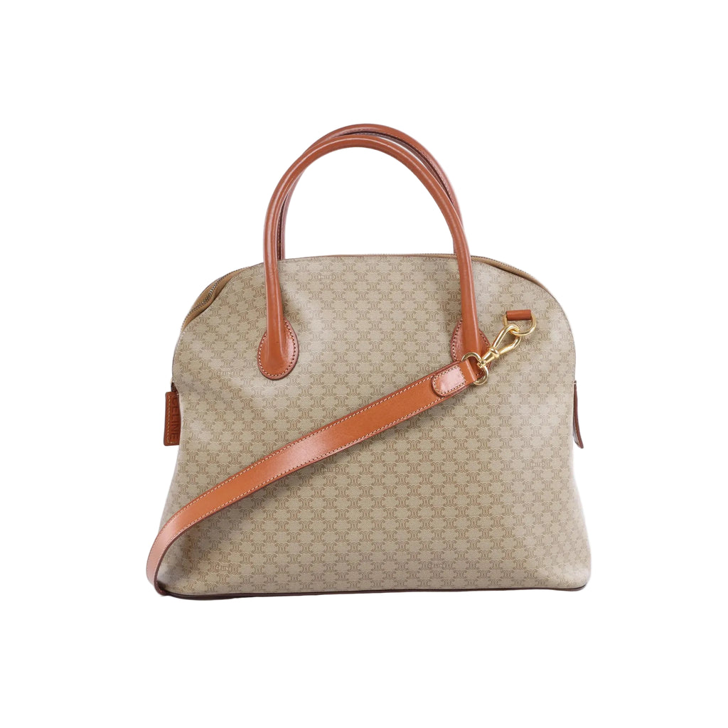 Front view of a beige Celine Macadam canvas handbag with brown leather top handles, gold-tone hardware and a detachable shoulder strap.