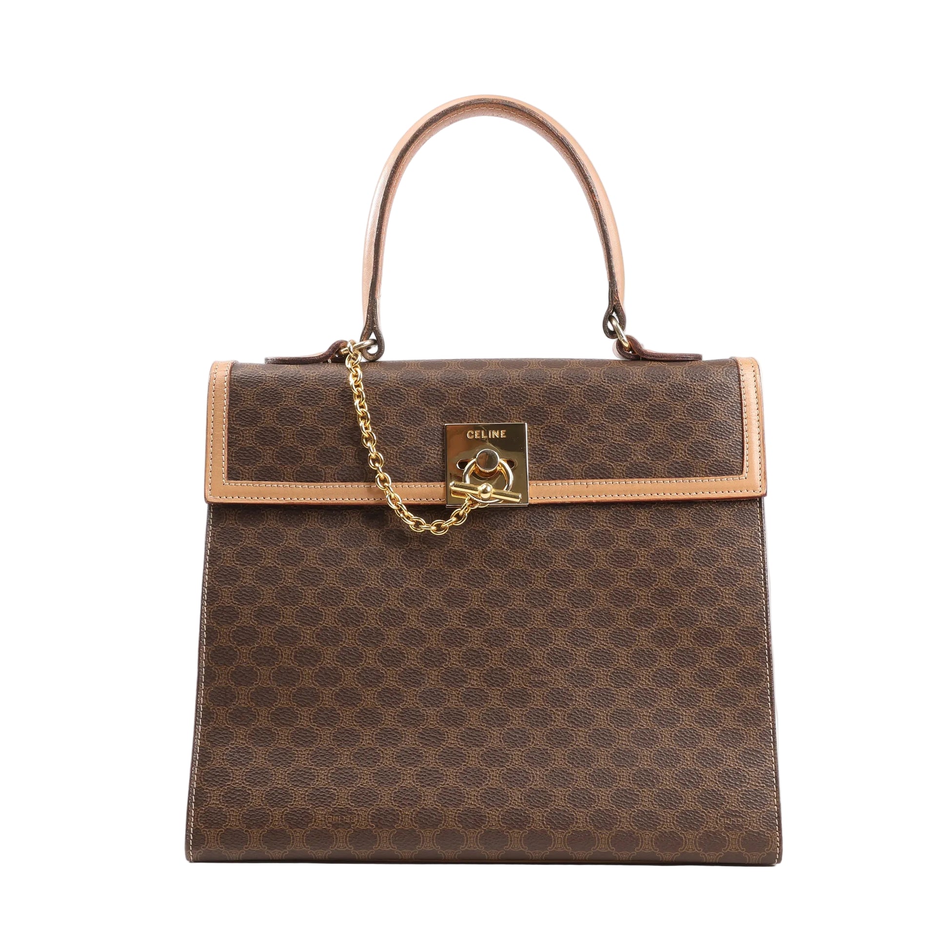 Front view of a Celine Macadam handbag in brown PVC canvas with tan leather trim, gold-tone chain and lock hardware, and a top handle against a white background.