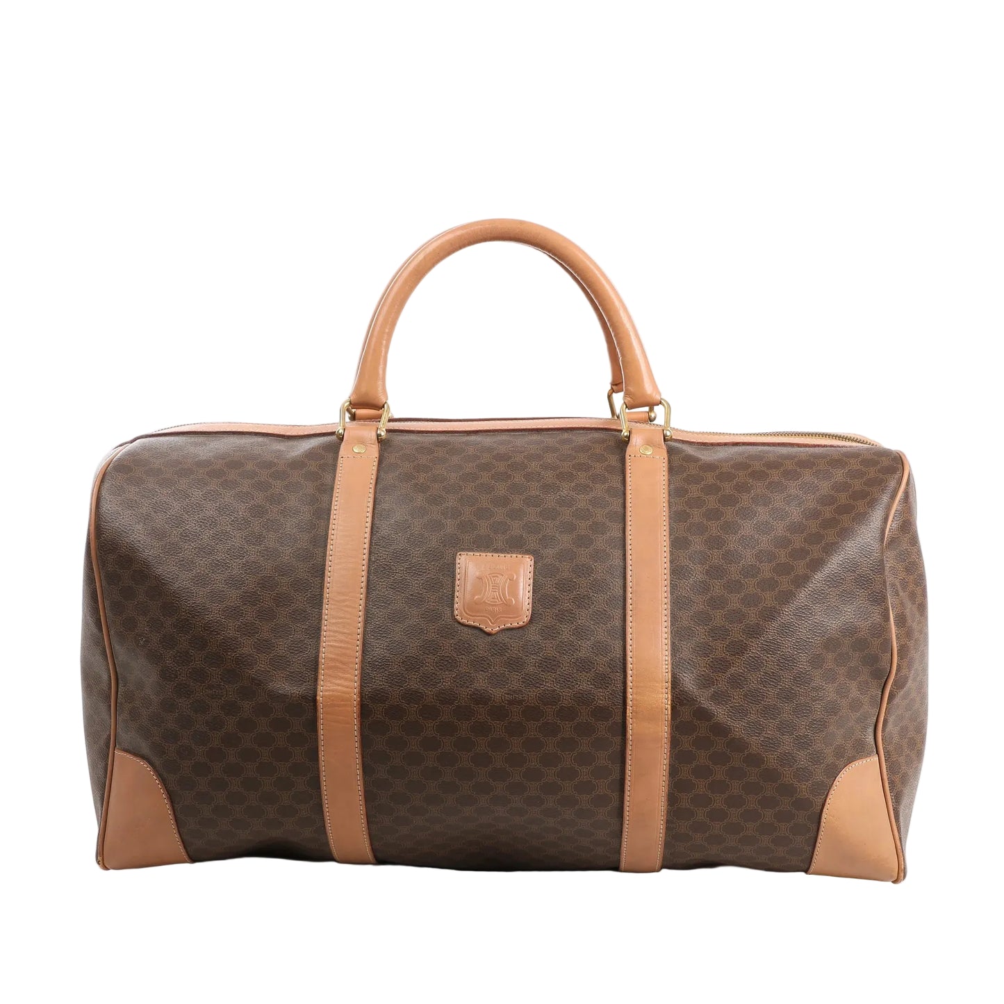Front view of a Celine Macadam Boston travel bag in brown coated PVC with tan leather trim, dual rolled handles, gold-tone hardware, and signature logo patch.