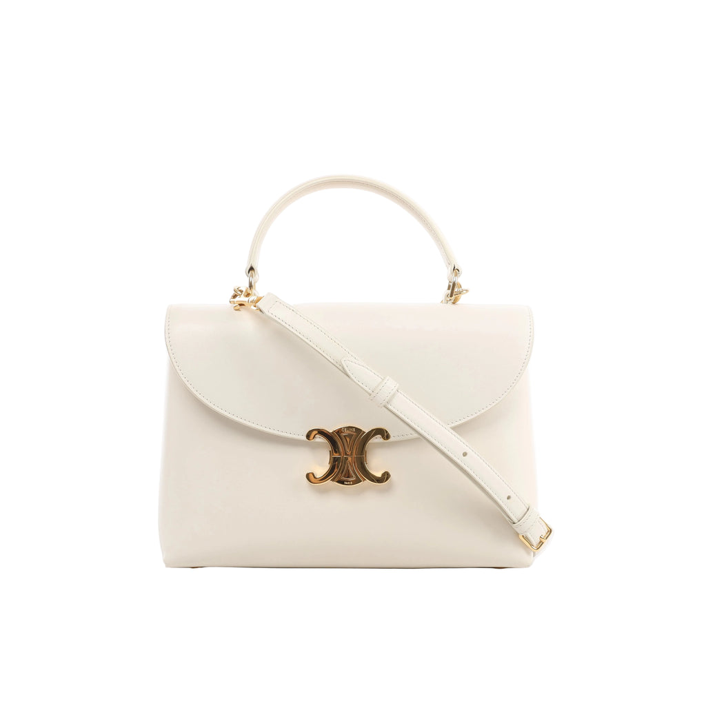 Front view of Celine Nino Medium beige leather handbag with a curved flap, gold-tone Triomphe clasp, rounded top handle and matching shoulder strap.