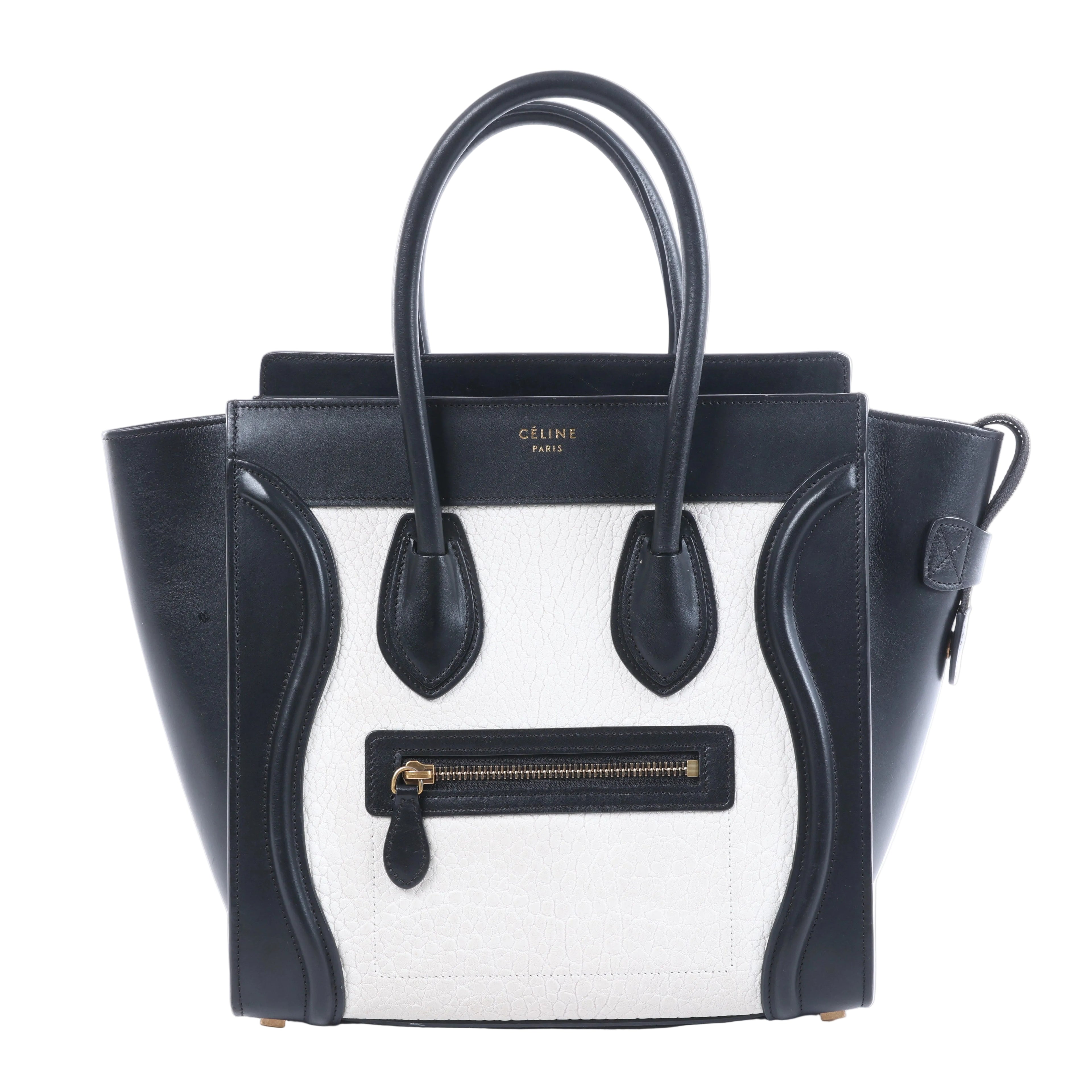 Celine Luggage Micro black and white leather handbag with top handles, winged sides and front zip pocket.