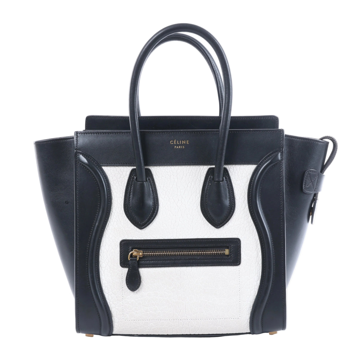 Celine Luggage Micro black and white leather handbag with top handles, winged sides and front zip pocket.