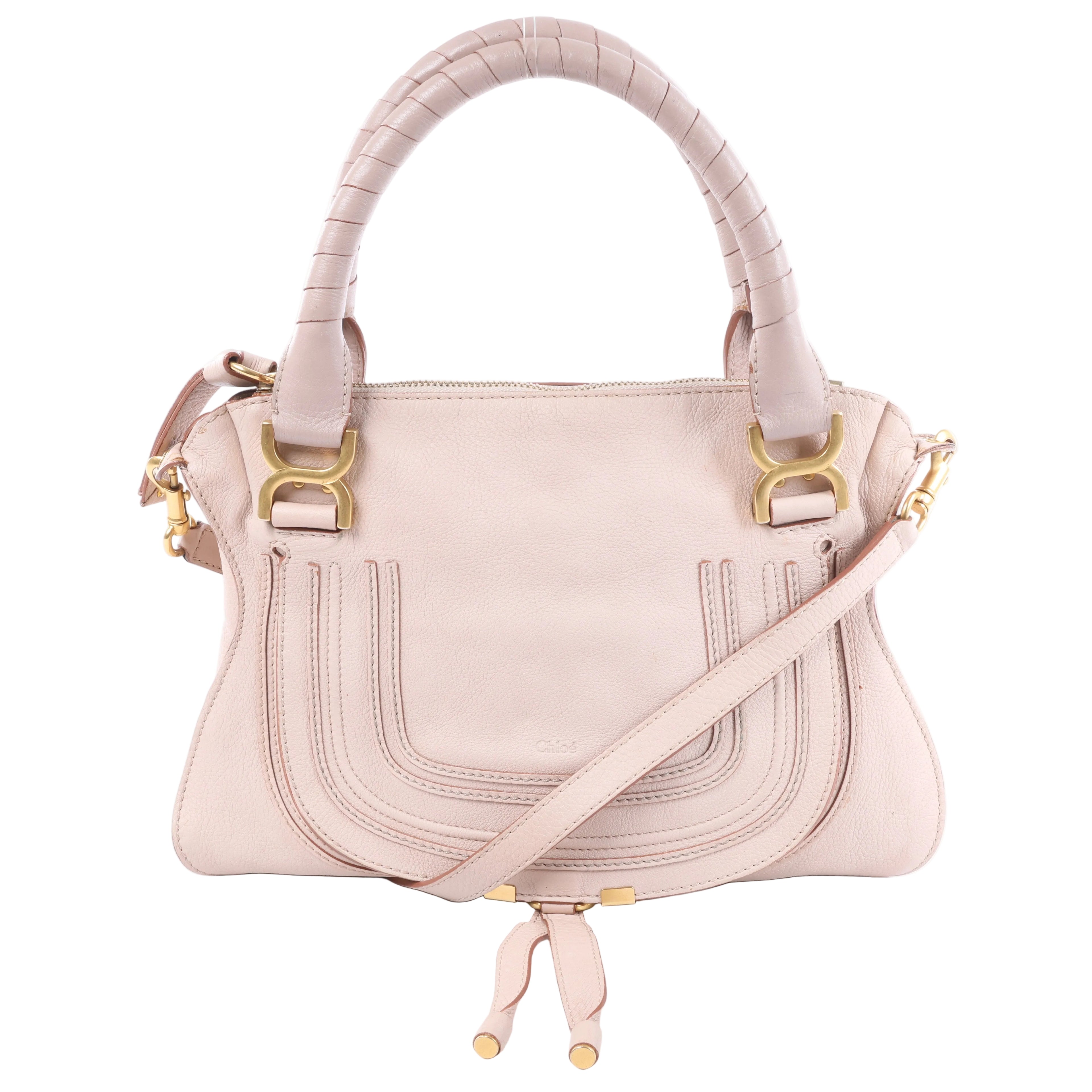 Chloé Marcie pink leather handbag with wrapped top handles, curved front stitching, gold-tone hardware and detachable shoulder strap.