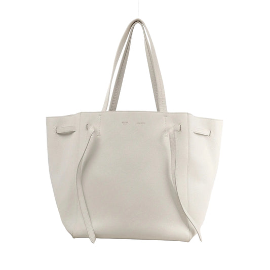 Celine Cabas Phantom Small Shoulder Bag in white grained leather with double handles, side tie details, and minimalist branding on the front.