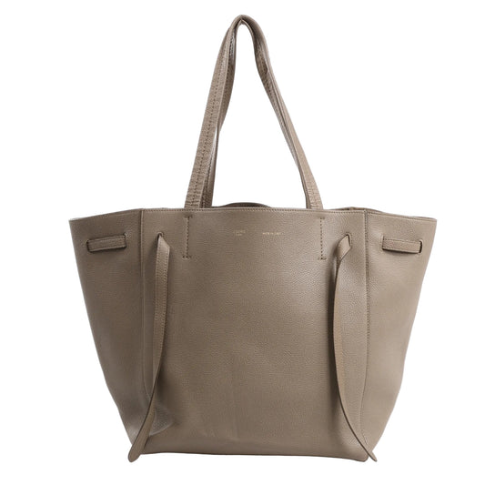 Celine Cabas Phantom Small Shoulder Bag in taupe grained leather featuring a structured tote silhouette, flat handles, and extended side ties.