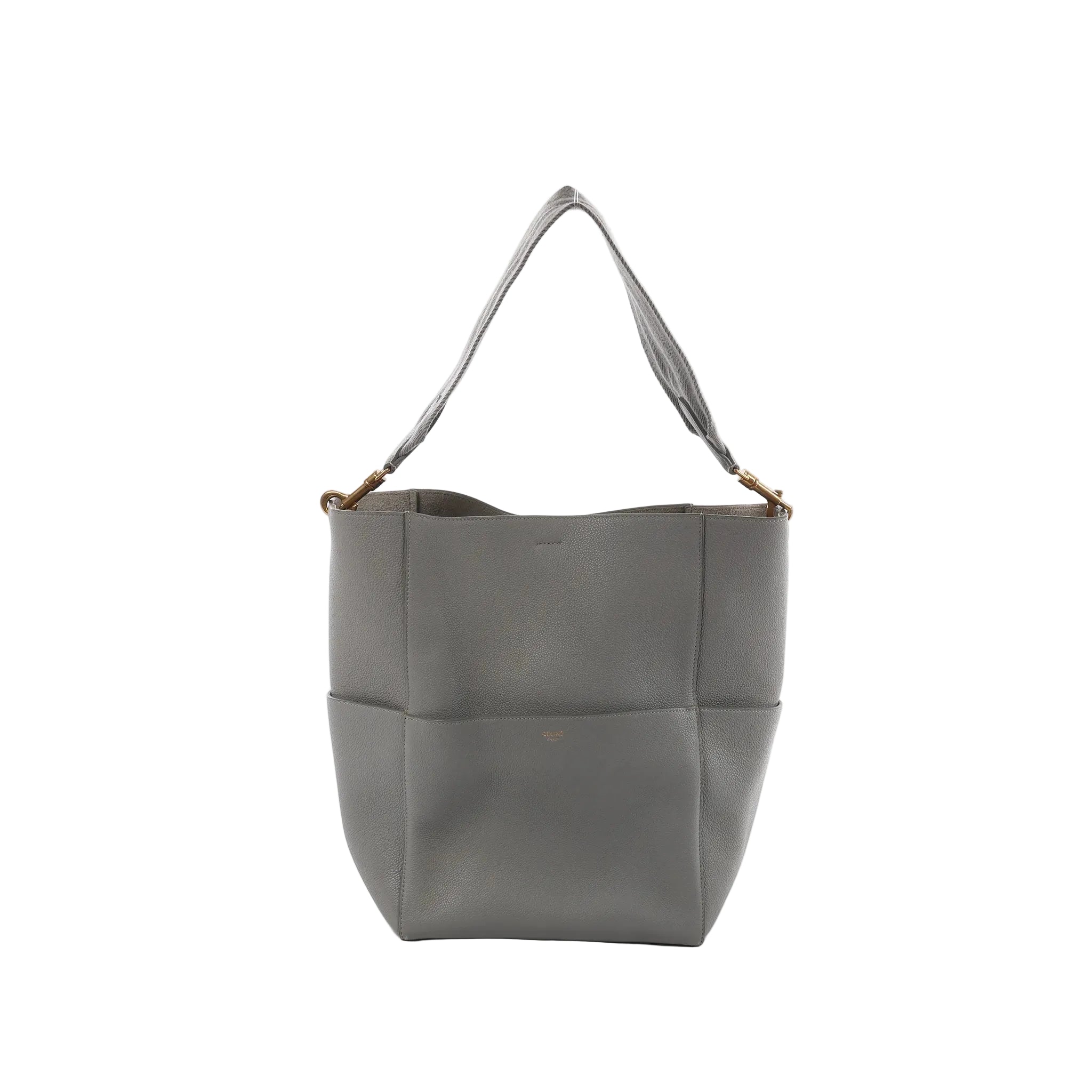 CELINE Seau Sangle bucket shoulder bag in gray pebbled leather with wide fabric shoulder strap and gold-tone hardware on a white background.