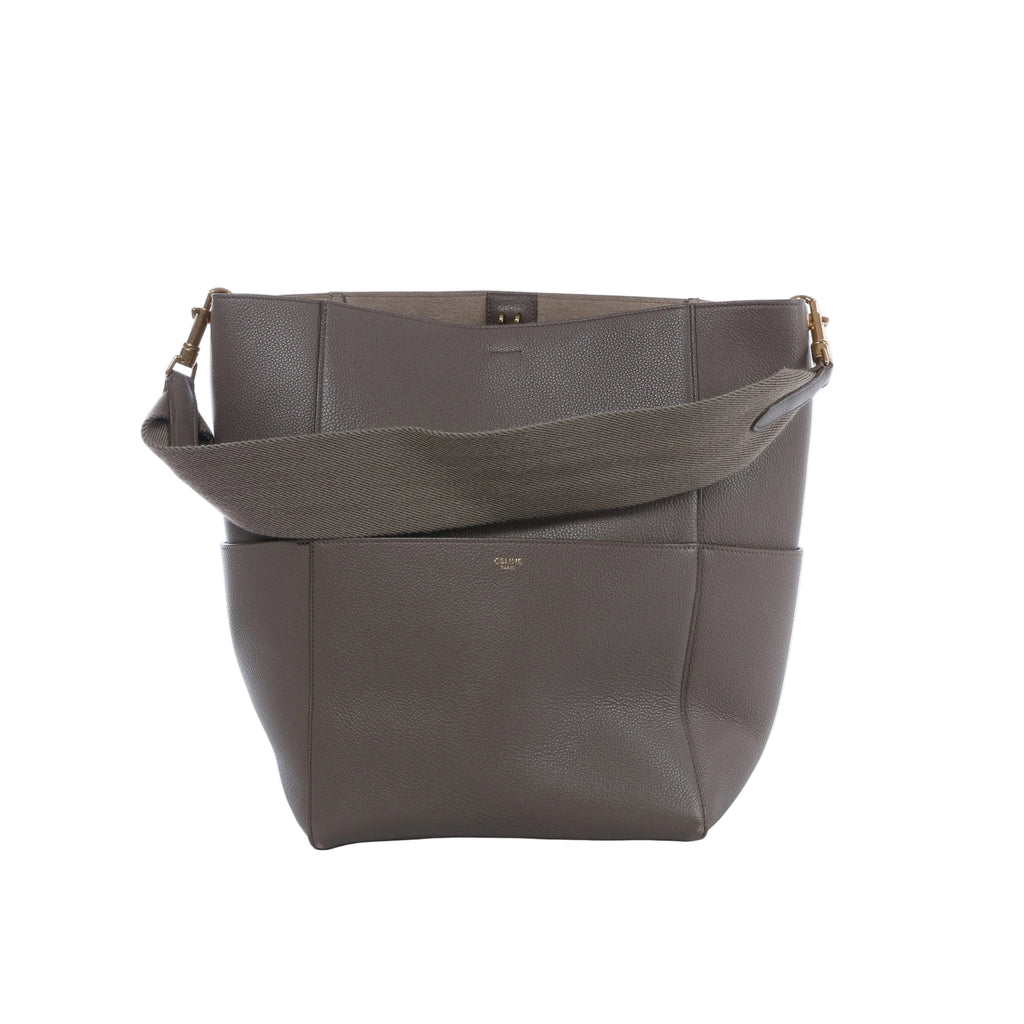 Gray Celine Sangle Bucket leather shoulder bag with pebbled texture, wide tonal textile strap and gold-tone hardware.