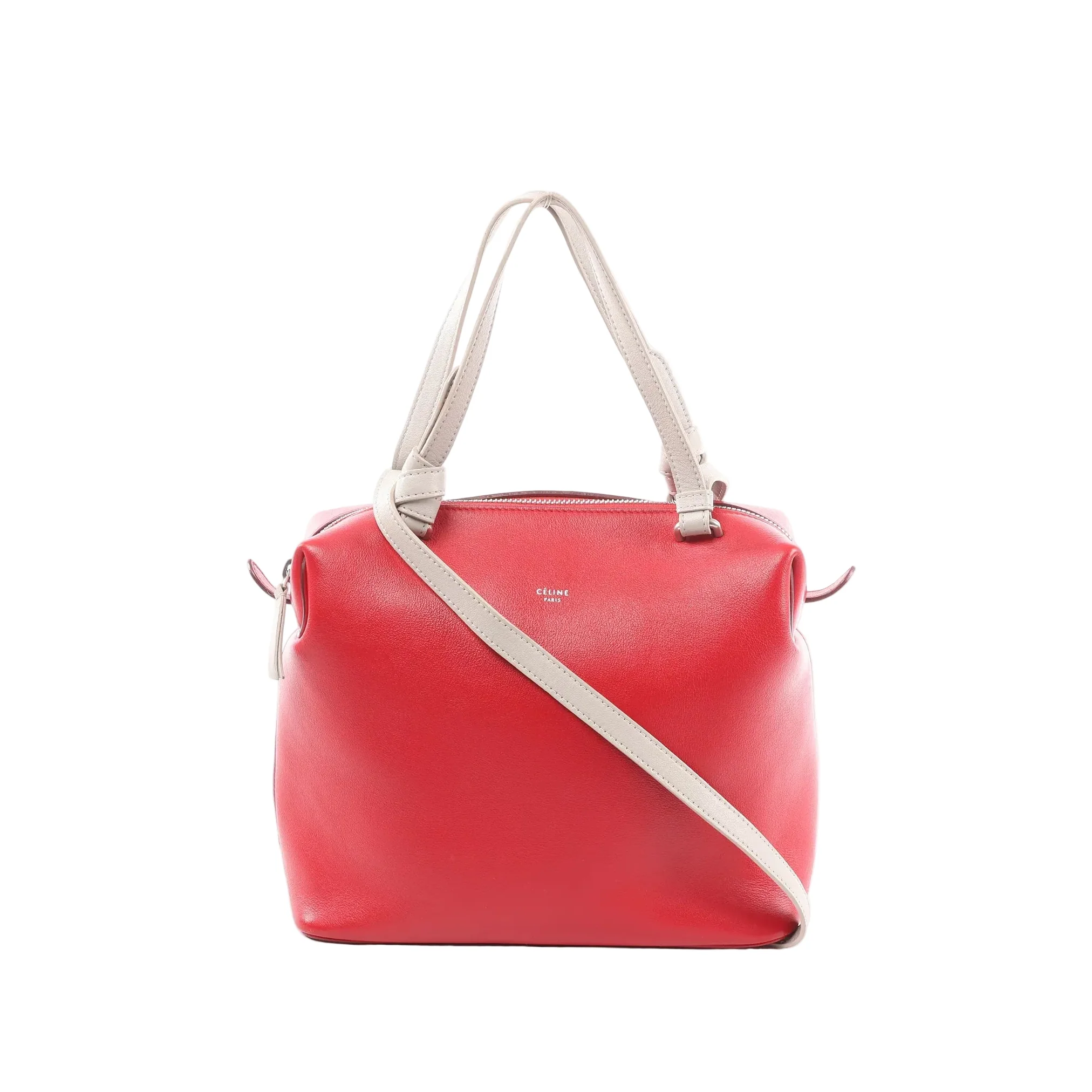 Red Celine Soft Cube Small leather handbag with beige top handles and shoulder strap, zip-top closure, and Celine Paris logo, front view on white background.