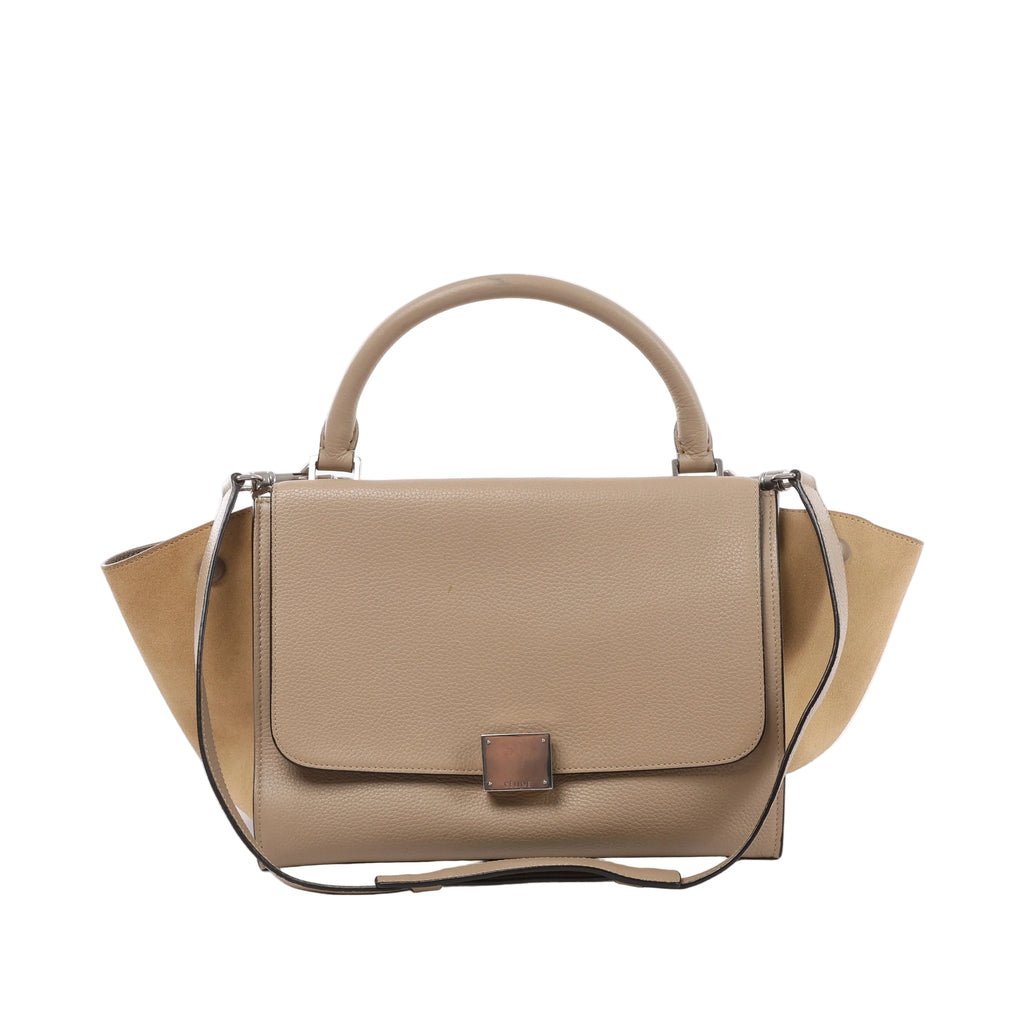 Beige Celine Trapeze leather handbag with top handle, shoulder strap, winged side panels, front flap and silver-tone clasp hardware.