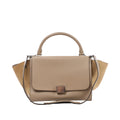 Beige Celine Trapeze leather handbag with top handle, shoulder strap, winged side panels, front flap and silver-tone clasp hardware.