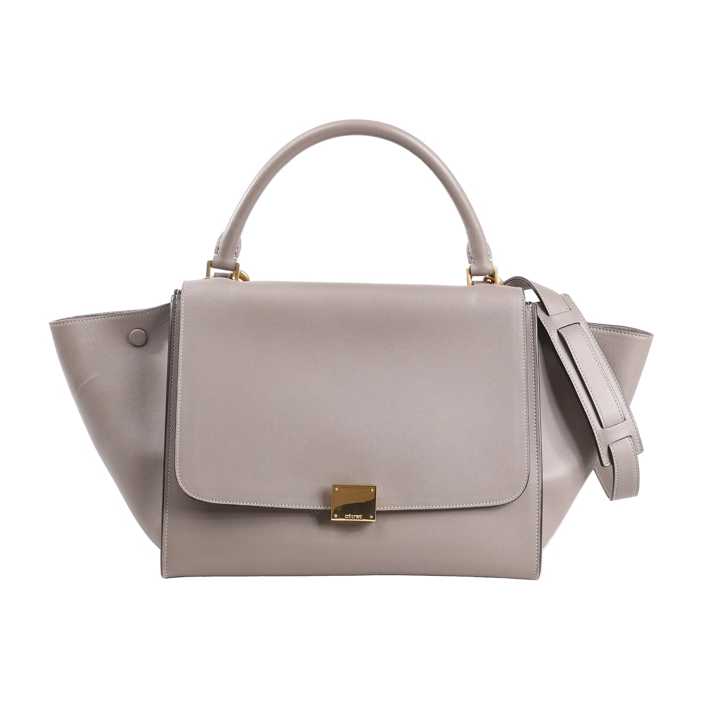 CELINE Trapeze 2Way Handbag in gray leather and suede, featuring a structured silhouette with winged sides, a top handle, detachable shoulder strap, and gold-tone square clasp on the front flap, set against a white background.