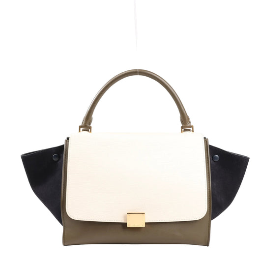 CELINE Trapeze 2Way handbag in beige leather with black suede side wings, khaki green base, top handle, and gold-tone front clasp, structured with modern elegance.