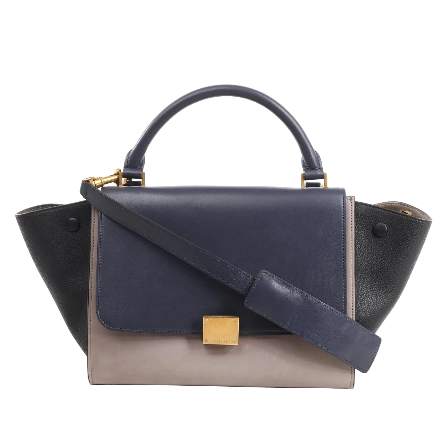 CELINE Trapeze 2Way handbag in navy blue, taupe, and black leather featuring a top handle, flap front with gold-tone clasp, and detachable shoulder strap.