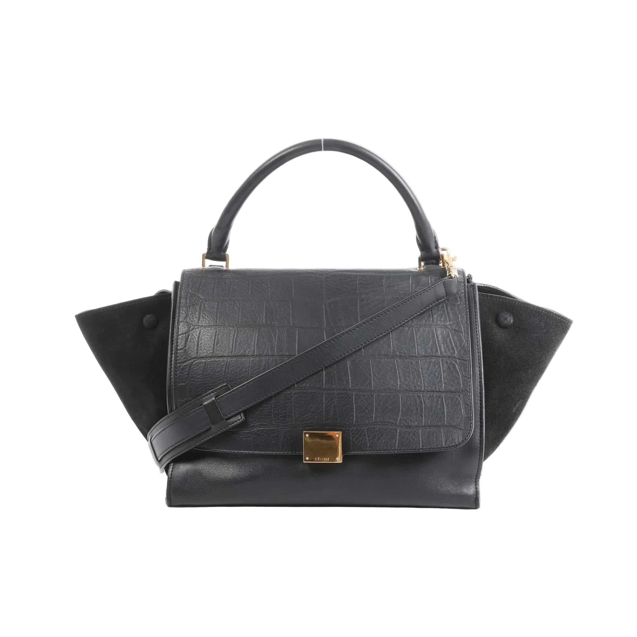 Black Celine Trapeze handbag in croc-embossed leather and suede with top handle, shoulder strap, side wing panels, and gold-tone front clasp on a white background