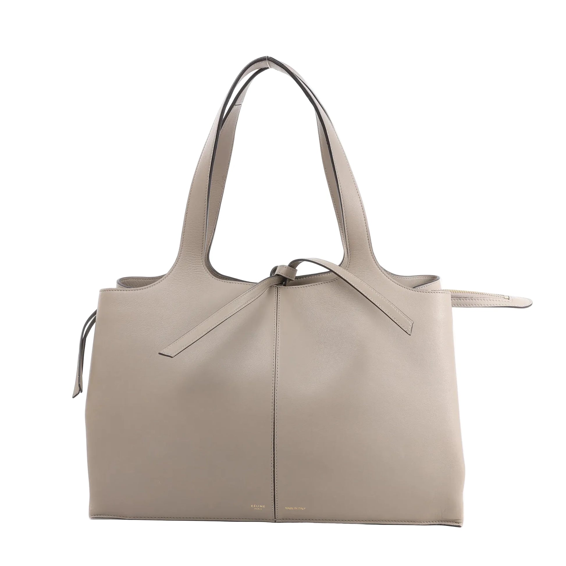 Celine Tri-Fold Shoulder Bag in smooth greige leather with dual slim handles, tie detail at the top, and structured rectangular silhouette against a white background.