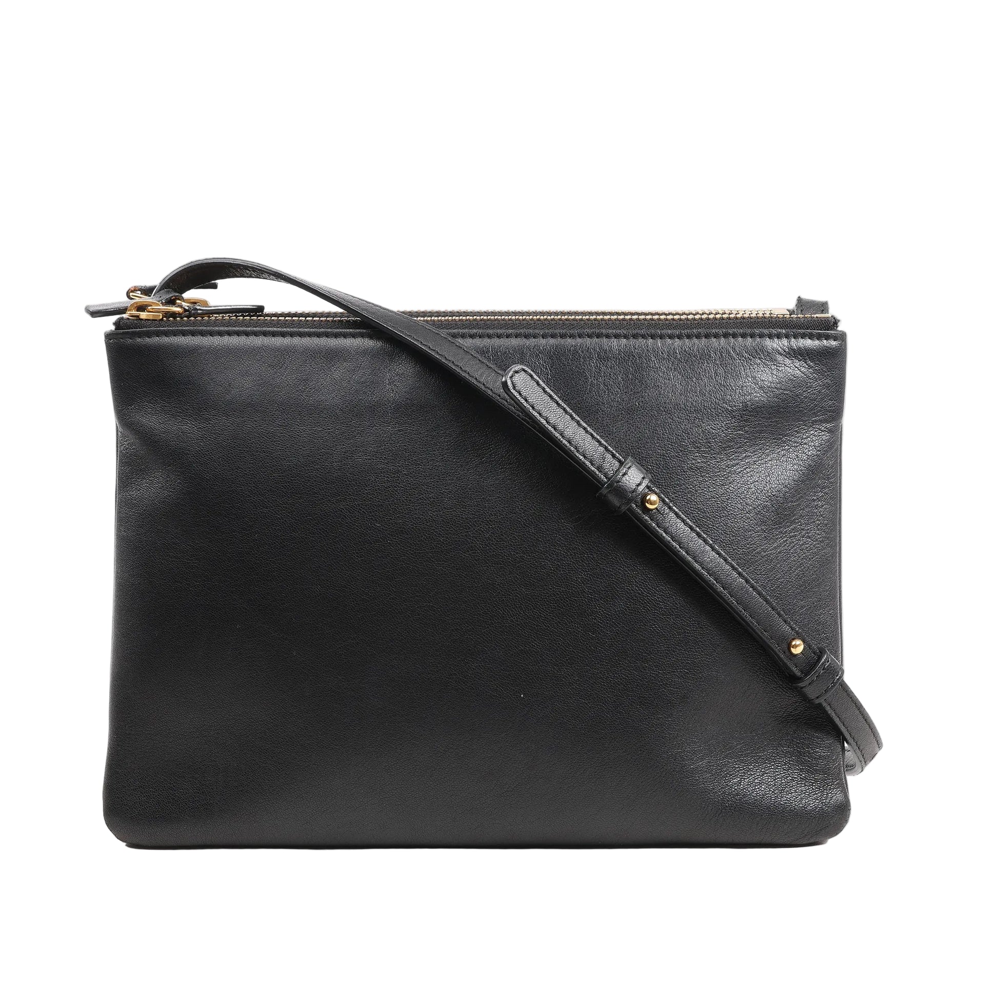 Front view of a Celine Trio Large Crossbody Bag in smooth black leather featuring a clean rectangular silhouette, adjustable leather shoulder strap with gold-tone hardware, and multiple zippered compartments.
