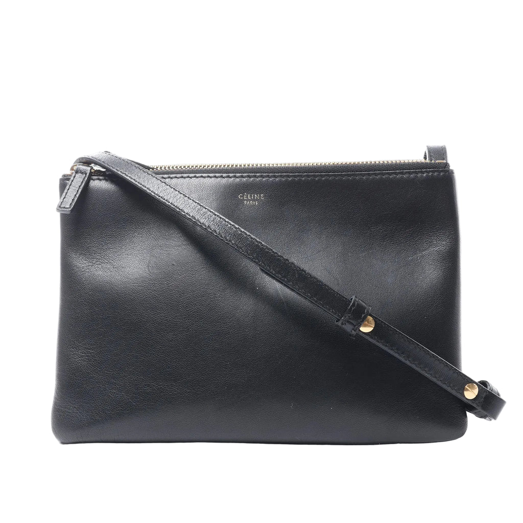 Celine Trio Small black leather crossbody bag with a rectangular shape, top zip closure, gold-tone logo and adjustable shoulder strap.