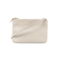 Celine Trio small crossbody bag in ecru leather with a minimalist rectangular shape, zip-top closure, gold-tone hardware, and slim shoulder strap on a white background.