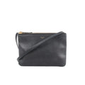 Black Celine Trio Small leather crossbody bag with zip-top closure, slim strap, and small gold logo on a white background