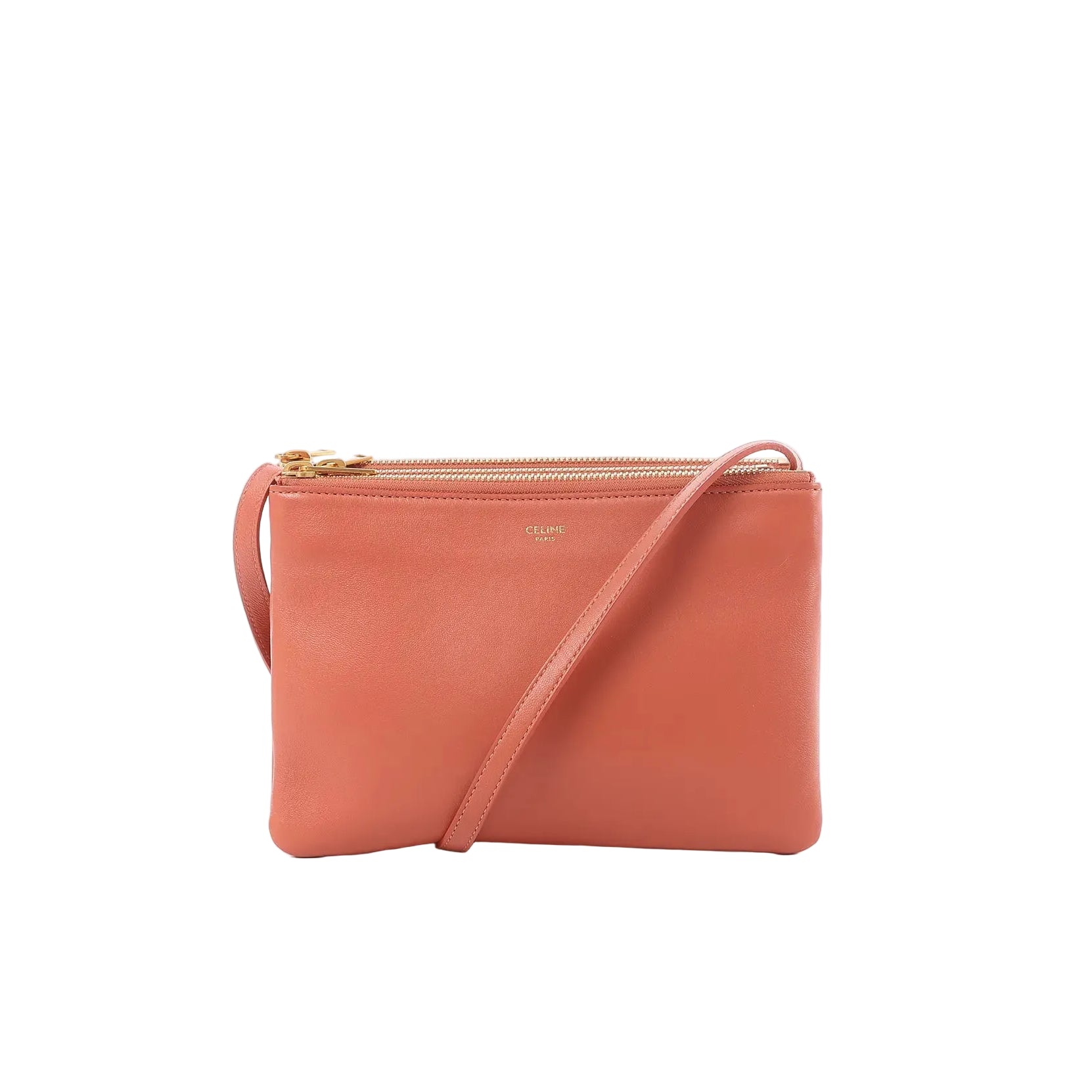 Celine Trio Small orange leather crossbody bag with slim shoulder strap, gold-tone zip-top closure, and small Celine logo stamp on the front.