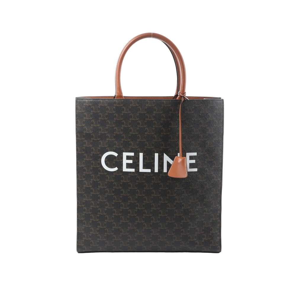 Front view of Celine Triomphe Vertical Cabas Large tote in black Triomphe-coated canvas with brown leather top handles and trim, large white CELINE logo, and hanging leather clochette.